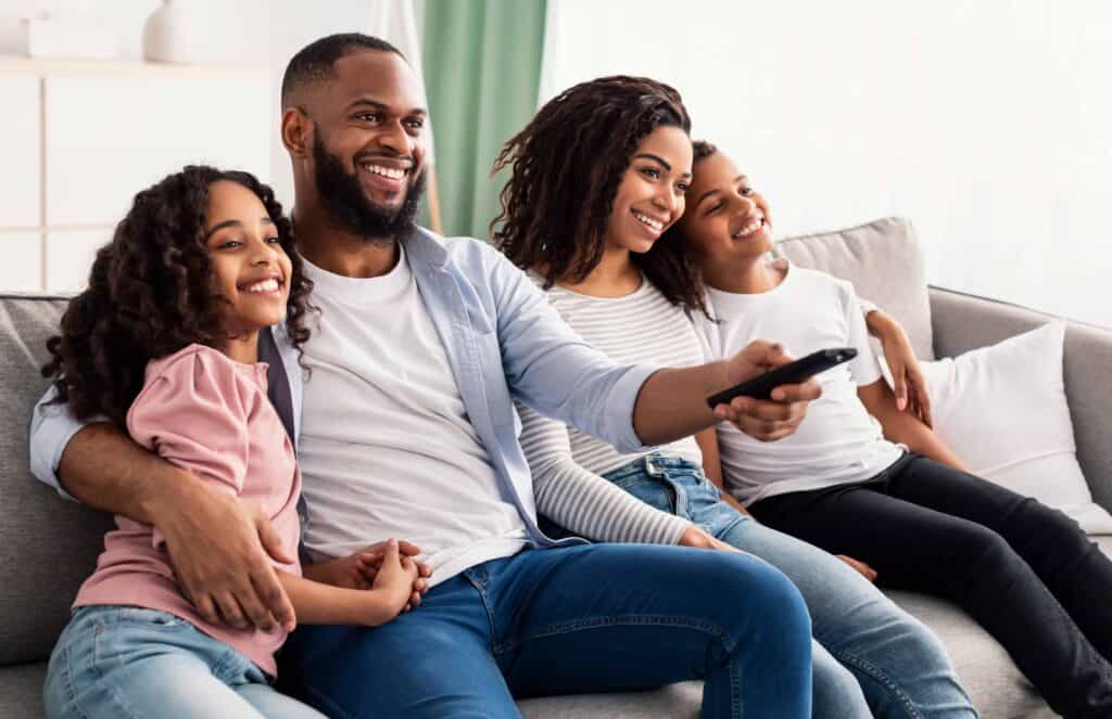 happy young black family watching television sitti lossy